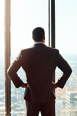 Image showing Thinking, building window and a business man with ideas, vision or plan for cityscape. Professional male entrepreneur with hands on hips for dream, growth and corporate development from behind