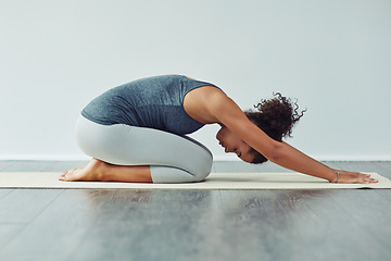 Image showing Yoga, child pose and woman stretching on mat for wellness, workout and fitness in gym studio. Healthy body, meditation and female person doing pilates exercise for balance, flexibility and wellbeing