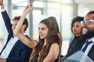 Image showing Business woman, hands raised and questions at conference, seminar or meeting. Smile, audience and hand up for question, asking or answer, crowd vote and group training at workshop presentation event.