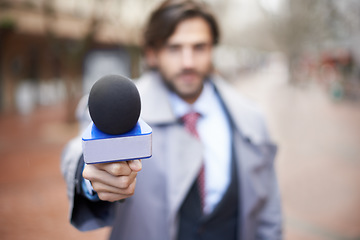 Image showing Interview, man and hand with microphone for press, news broadcast or question in the city. Tv journalist, conversation and a male reporter with a mic for discussion, interviewing and work in media