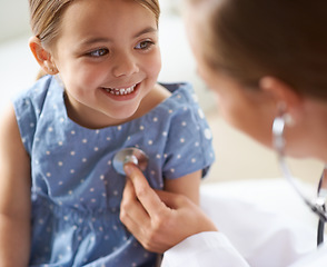 Image showing Happy, child and stethoscope of pediatrician for healthcare consulting, check lungs and breathing for heartbeat. Medical doctor, kid and chest assessment in clinic, hospital and helping girl patient