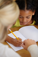 Image showing Teacher help student, education and writing in notebook with pencil, teaching and learning for growth and development. People in classroom to learn, academic study with young girl and woman at school