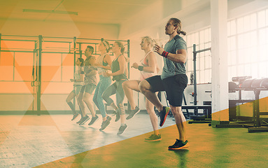 Image showing Group, gym exercise and personal trainer in cardio training or fitness, workout and class, club or team, practice or routine space. People, running and athletic body or friends exercising banner