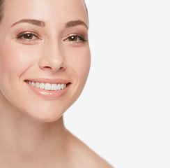 Image showing Smile, dental care and portrait of a woman with skincare isolated on a white background in studio. Happy, face and a young model showing teeth for oral hygiene with grooming for care of skin