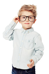 Image showing Nerd or geek, portrait of young child with glasses and in white background. Intelligent or smart, serious and isolated child adjusting his spectacles as a confident student in a studio backdrop