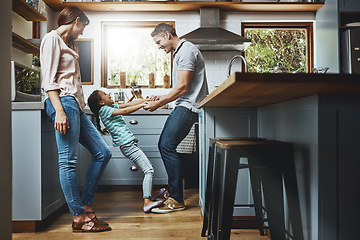 Image showing Kitchen, family and dance together in home or bonding, child and father holdings hands, love and quality time in house. Girl, dad and mom with affection, fun and relax or dancing and laughing