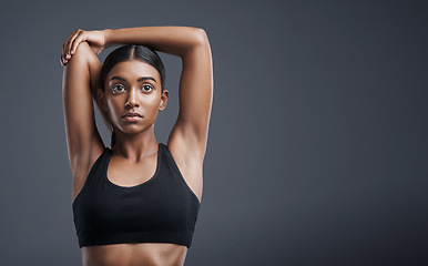 Image showing Fitness, wellness and stretching with an athlete woman in studio on a gray background for mindset or health. Exercise, mission and warm up with an attractive young female model training on mockup