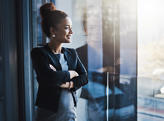 Image showing Business woman, window and smile for vision, goals and future of career with ideas, mission or mindset. Young businesswoman, focus and thinking in workplace with memory, reflection or corporate dream