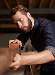 Image showing Carpenter, wood sanding and man working on building construction and architecture project. Home improvement, maintenance and handyman work of a young male employee with carpentry tool for woodwork