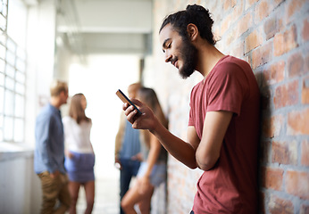 Image showing School, phone and relax with man in hallway for social media, technology or internet. Eduction, learning and scholarship with male student on university campus for connection, contact or text message