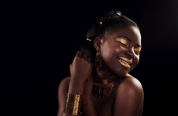 Image showing Beauty, gold and black woman in studio for makeup, art and elegance against a black background. Rich, creative and African female model pose with jewelry for wealth, royal and luxury queen aesthetic