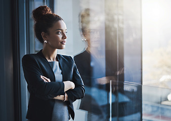 Image showing Business woman, window and thinking for vision, goals and future of career with ideas, mission and mindset. Young businesswoman, focus and ambition in workplace with memory, reflection and dream