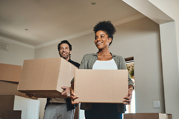 Image showing Happy couple, real estate and moving in with boxes for renovation, investment or relocation in new home. Interracial man and woman realtor owner carrying box in house, move or property loan together