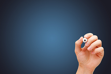 Image showing Hand Holding White Marker On Dark Blue Background