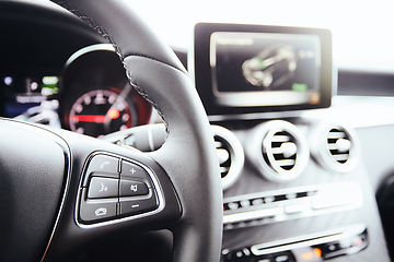 Image showing Control buttons on steering wheel. Car interior.