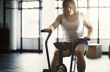 Image showing Fitness, elliptical and man training in gym, workout or exercise for strength, health or wellness. Sports fatigue, tired and exhausted male athlete exercising, cardio or cycling on cross trainer bike