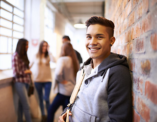 Image showing Education, smile and portrait of student in college hallway for studying, learning and scholarship. Future, happy and knowledge with man leaning against wall for university, academy and campus