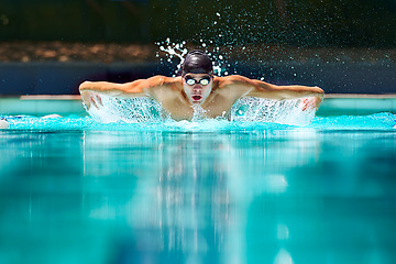 Image showing Fitness, sport and training with man in swimming pool for competition, workout and energy. Strong, water splash and cardio with male swimmer and practice for athlete, championship and race at gala