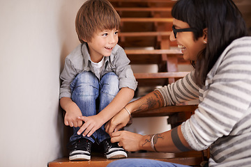 Image showing Learning, tying and shoes with mother and kid for child development, bonding and helping. Happy, smile and support with woman and young boy on steps in family home for laces, care and happiness