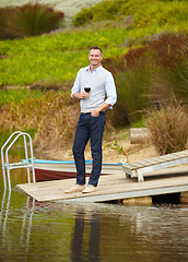 Image showing Portrait, lake and mature man with red wine, vacation and smile on a weekend break, getaway and happiness. Face, male person and happy guy on a summer holiday, alcohol and outdoor to relax and chill