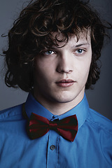 Image showing Fashion, face of man in shirt and bow tie on studio background with aesthetic geek style and serious expression. Elegant beauty, formal and unique nerd clothes on gen z male model on grey backdrop.