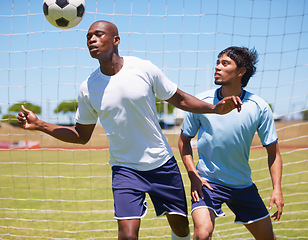 Image showing Men, sport and soccer with header, ball and contest for defender and striker on field for wellness. Man, football player and competition to stop goal, exercise or training together for health outdoor