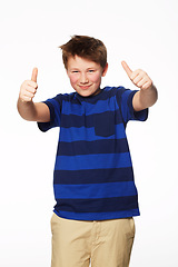 Image showing Portrait, thumbs up and smile of kid in studio isolated on a white background. Boy, hand gesture and child with like emoji for agreement, success or thank you, yes sign and winner, ok and approval.