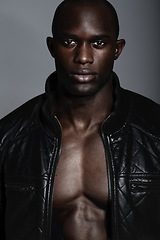 Image showing Fashion, portrait and black man in leather jacket in studio isolated on a gray background. African male model, serious face and coat, confidence and stylish clothes or trendy outfit from Nigeria.