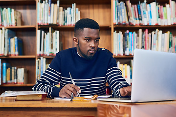 Image showing Library, laptop and university student with research, learning and planning for exam, report or focus on computer, studying or education. Black man, college and working on task, essay or scholarship