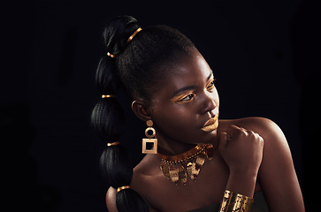 Image showing Gold, beauty and black woman in studio for makeup, art and elegance against a black background. Rich, creative and African female model pose with jewelry for wealth, royal and luxury queen aesthetic