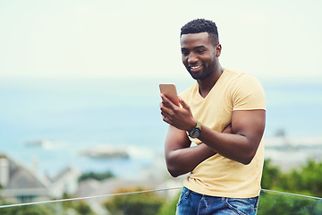 Image showing Outdoor, space and black man on phone or social media, app or technology for email communication, mockup and blue sky. Smartphone, online networking or internet conversation on screen with smile