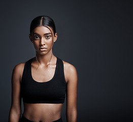 Image showing Portrait, serious and Indian woman with mockup, exercise and workout goal on dark studio background. Face, female person pr athlete with fitness, healthy girl or wellness with progress or development