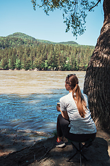 Image showing Woman on river coast