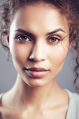 Image showing Beauty, beautiful and portrait of woman in studio confident, attractive and gorgeous on gray background. Salon, facial glow and face of female person in natural makeup, cosmetics and curly hairstyle