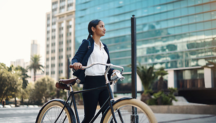 Image showing Travel, city and professional woman with a bicycle in the morning walking in the street to work. Eco friendly, transport and business female employee commuting to the office with a bike in urban town