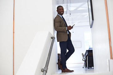 Image showing Portrait, happy man and typing on cellphone in office for online contact, mobile technology or mockup. Black male worker, business and texting on smartphone, networking app or connect to social media