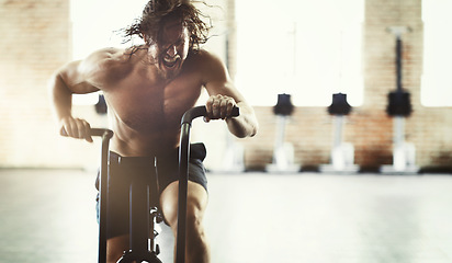 Image showing Workout, fitness and man on elliptical in gym for health, training or exercise. Sports, motivation and determined male shouting on cross trainer bike for exercising, cardio and cycling for strength.