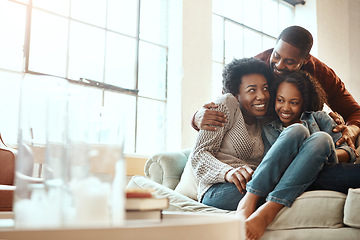 Image showing Love, bond and family hugging while relaxing together in the living room of their modern house. Happy, smile and African parents spending quality time, talking and hugging girl child on sofa at home.