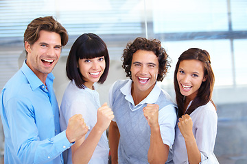 Image showing Business people, portrait smile and fist in celebration for winning, teamwork or success at the office. Happy and excited employees standing together in happiness for victory, win or team promotion