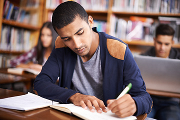 Image showing Study, writing and college with man in library for education, research and classroom quiz. Focus, learning and notebook with male student on university campus for knowledge, scholarship and project