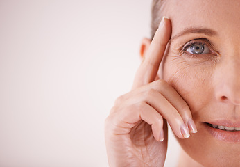 Image showing Eye, portrait and senior woman skincare on mockup or zoom on face in studio backdrop. Eyecare for wellness, beauty or aesthetic model happy about cosmetic makeup, manicure and health on background