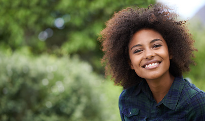 Image showing Black woman outdoor in portrait, smile in nature with positive mindset with mockup space. Headshot of happy female person, young and carefree with curly afro hairstyle and happiness at the park