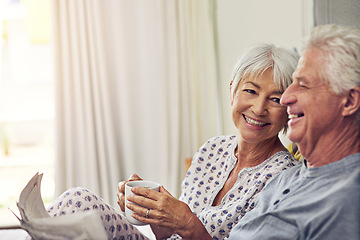 Image showing Coffee, newspaper and a senior couple in bed, enjoying retirement in their home in the morning. Tea, reading or love with a happy mature man and woman in the bedroom together to relax while bonding