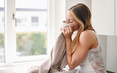 Image showing Woman, smelling laundry and clothes in basket with happiness for clean clothes in living room. Female person, cleaning and fabric for housework or lifestyle of enjoyment in apartment at home.