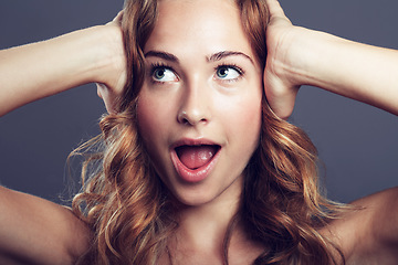 Image showing Surprise, thinking and face of an excited woman with a smile isolated on a dark background in a studio. Wow, idea and a young female model with expression of shock from makeup and cosmetics ideas