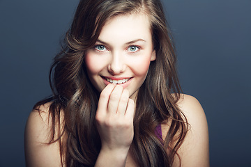 Image showing Beauty, face and skin portrait of a woman in studio with a smile, makeup and cosmetics. Headshot of a happy gen z female model on a grey background for natural glow, hair care and dermatology