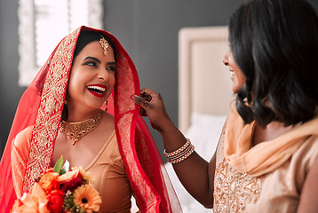 Image showing Happy, bride and bridesmaid getting ready for a wedding, laughing and helping in a room. Support, love and a young woman in traditional Indian clothes for marriage ceremony with a friend or sister