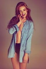 Image showing Woman, excited wink and portrait with casual fashion and smile in a studio. Sexy, flirty and female model with happiness and style with isolated blurred background feeling confident and empowerment