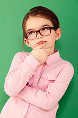 Image showing Thinking, ideas and girl with focus, green screen and thoughts against a studio background. Kid, female child and young person with wonder, opportunity and ponder with facial expression and future