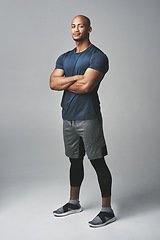 Image showing Arms crossed, fitness and portrait of man isolated on studio background for healthy body and workout. Confident, happy and strong athlete, bodybuilder or African person with exercise for sports power